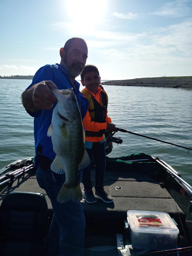 boy and father with sea bass caught in El Cuchillo Lake, La China, Nuevo Leon, Nuevo Leon