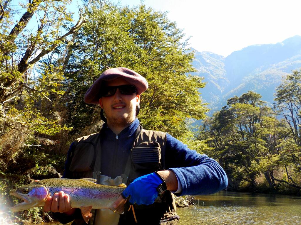 Angler shows his trout catching in Villa la Angostura, Argentina / Pescador deportivo muestra captura de trucha en Villa la Angostura, Argentina