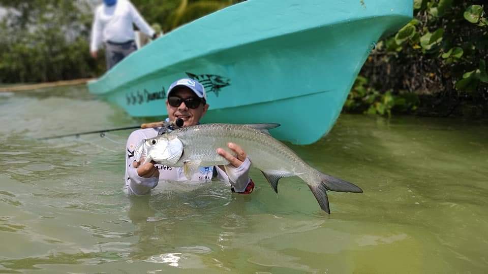 Angler releases a juvenile tarpon in Chetumal Mexico