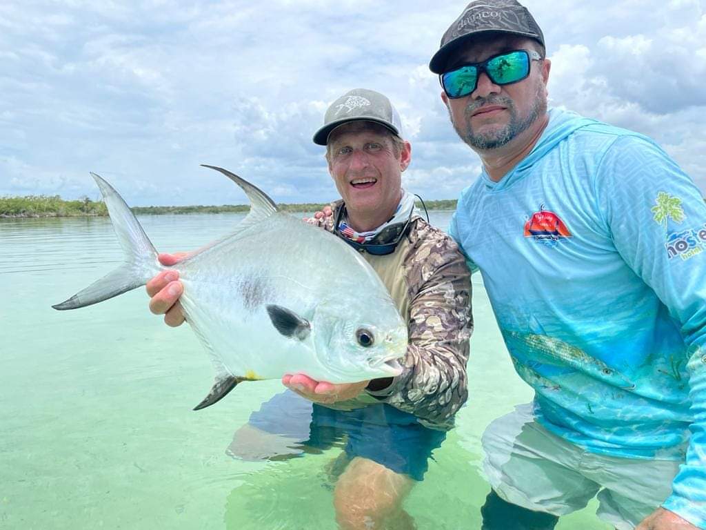 guide and angler showing a permit caught in Chetumal Mexico