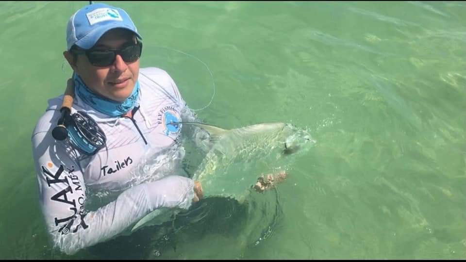 sport fishermen showing a big permit caught in Chetumal Mexico