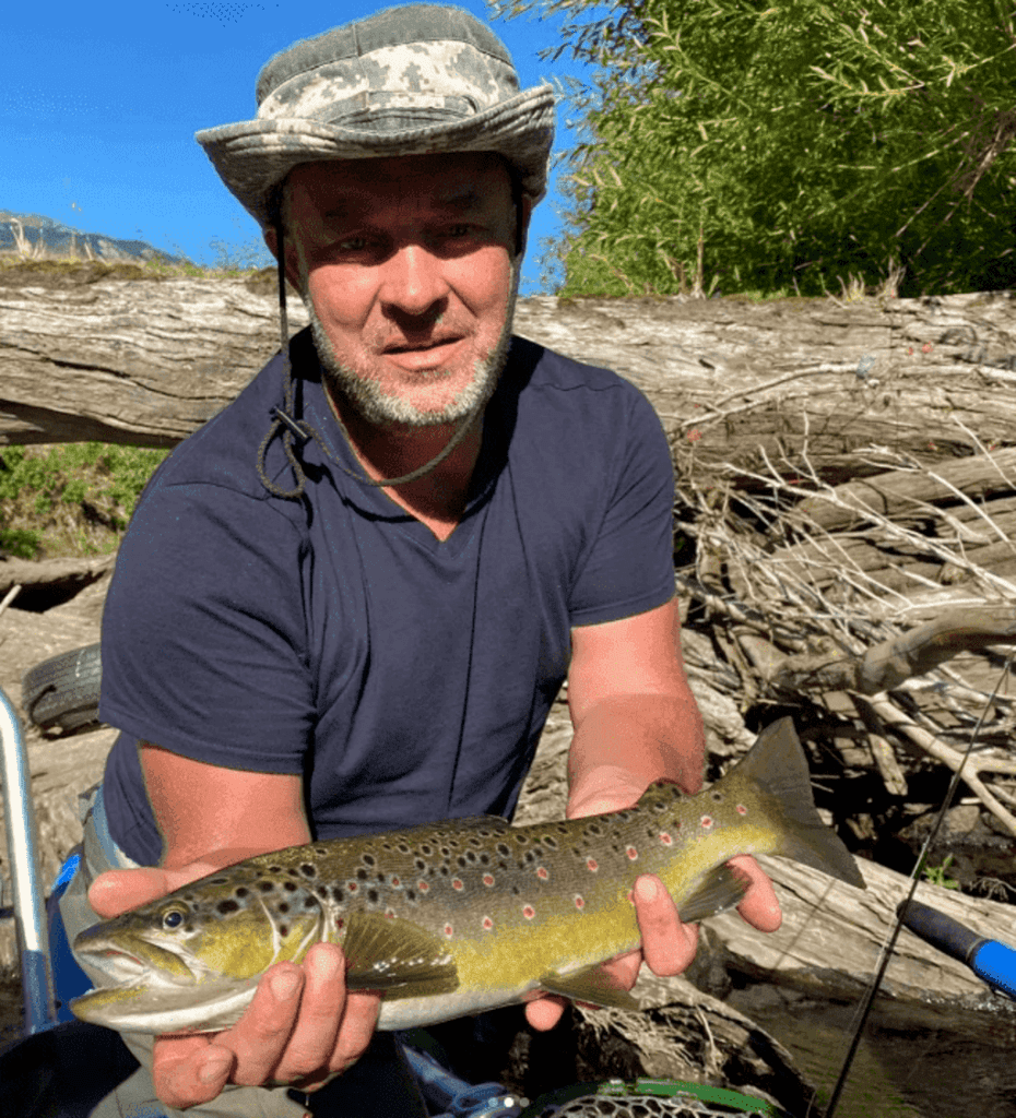 Angler with brown trout Simpson River Mañihuales Chile