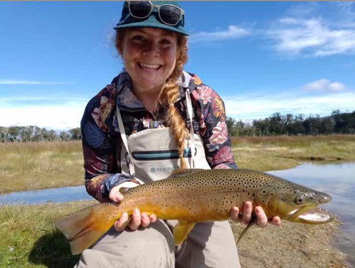 Girl with brown trout catch Isla Grande Tierra de Fuego Argentina