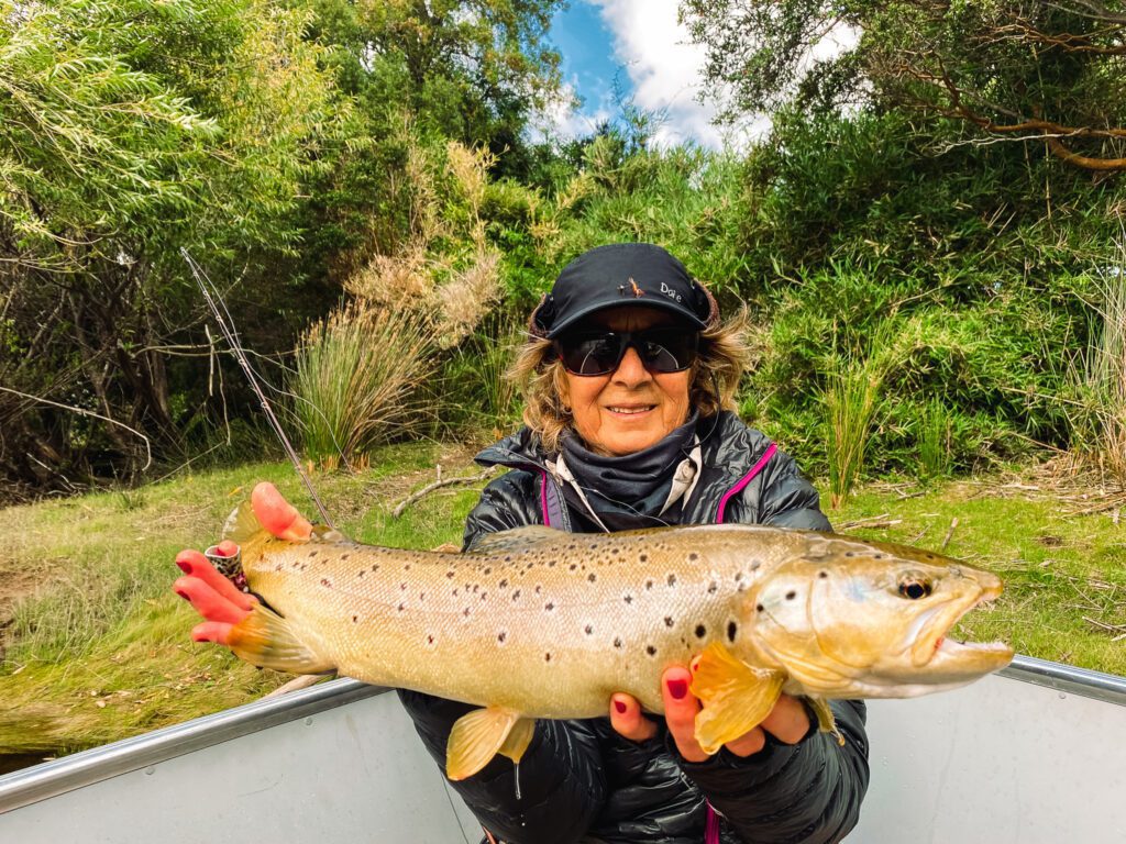 Angler with brown trout at Lake Lonconao La Patagonia Chile