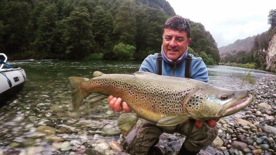 Angler with brown trout at Palena La Patagonia Chile
