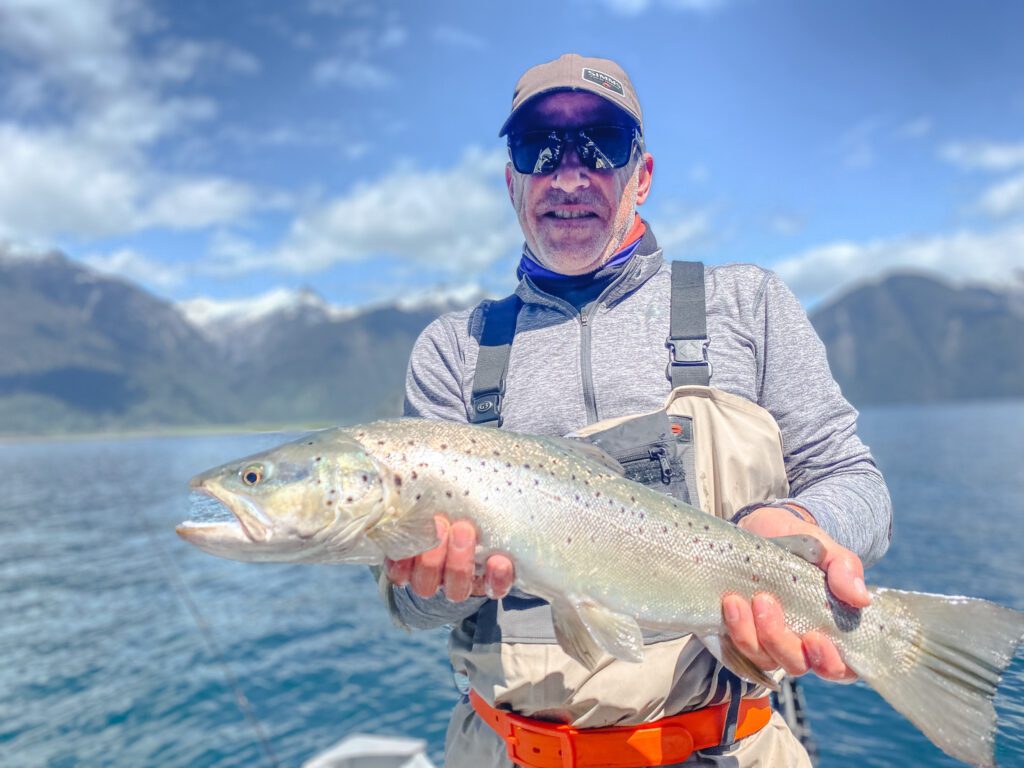 Angler with raibow trout at Lake Futaleufú Chile