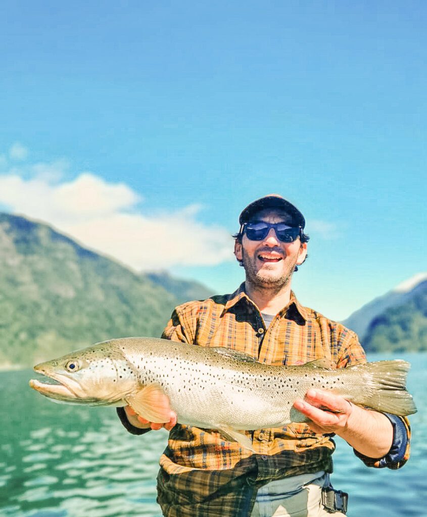 Angler with raibow trout at Lake Malito La Patagonia Chile