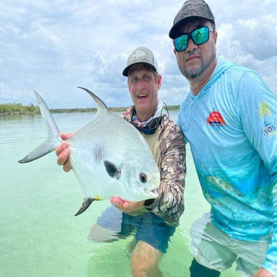 Happy angler with his Beautiful permit catch at Chetumal