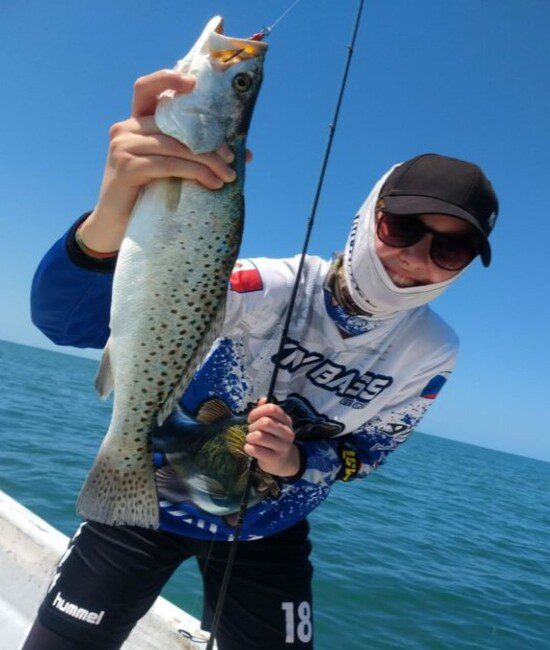 Happy angler and her beautiful spotted trout catch at Celestun